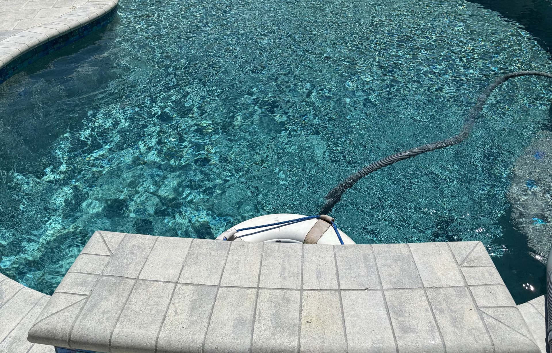 Pool vacuum robot and crystal clear water after professional cleaning