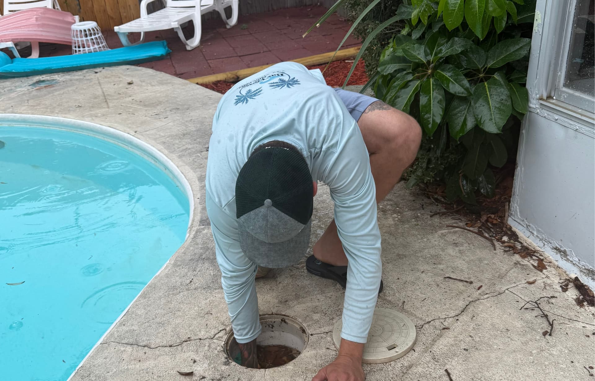 Technician performing pool equipment maintenance and filter service